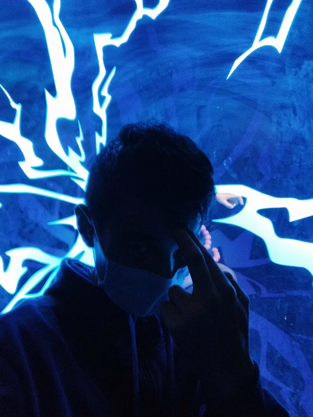 Illuminated by a blue neon lightning display